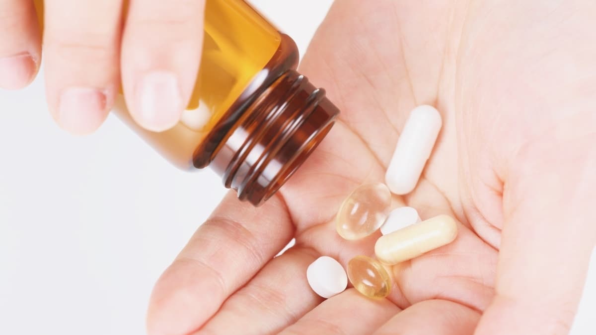 MedExpress online pharmacy prescription pills and capsules in hand with medicine bottle