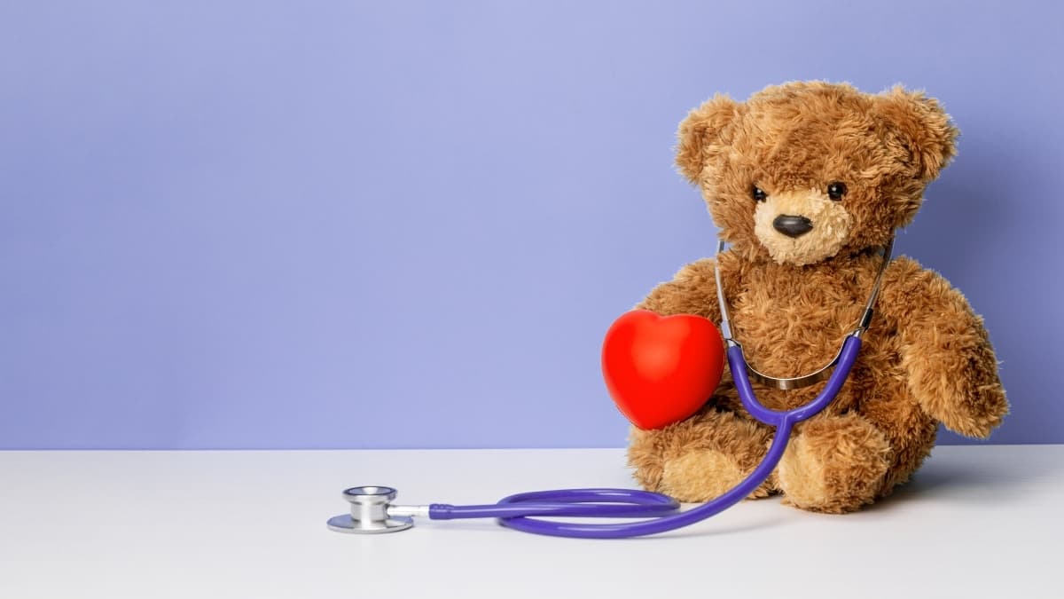 Online health consultation concept with teddy bear and stethoscope