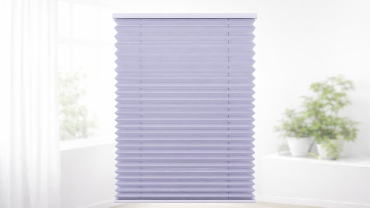Schattenfreu Thermal Pleated Blind in light lavender installed on modern window with soft daylight and potted plants in bright minimalist room