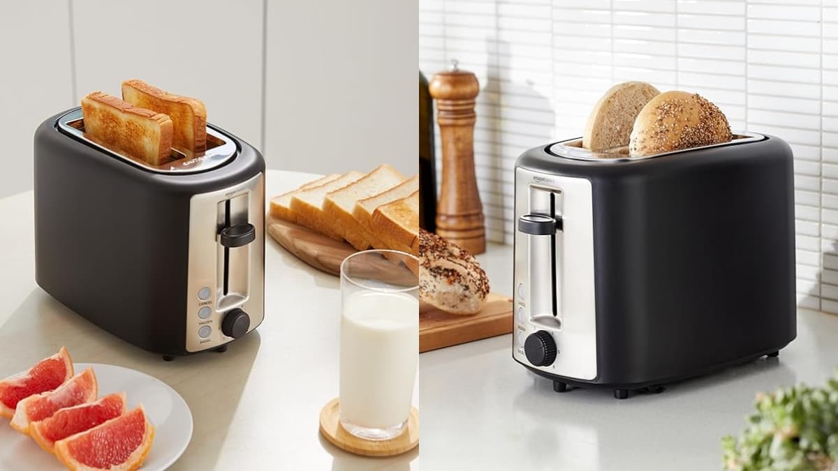 Black 2-slice Amazon Basics toaster with bagels and toast in extra wide slots on a kitchen counter.