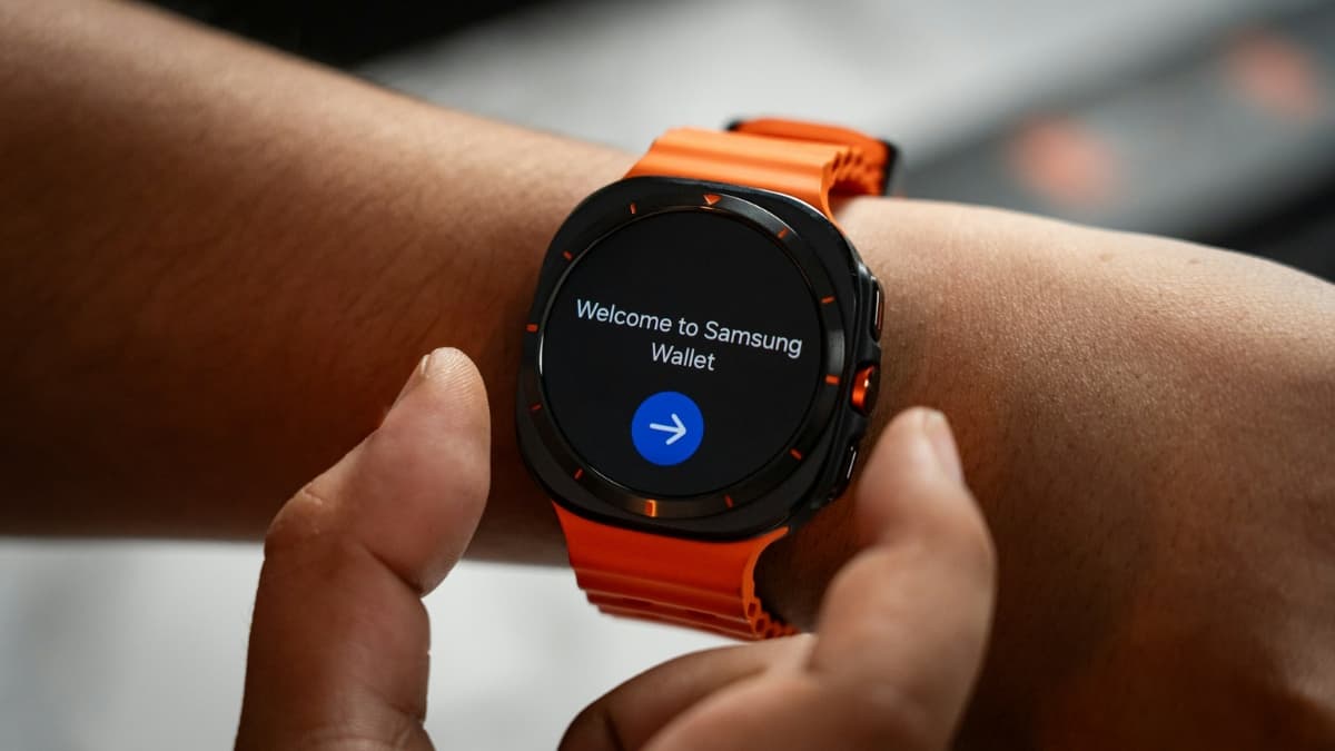 Person using a Samsung Galaxy Watch Ultra with an orange band, displaying the Samsung Wallet welcome screen.