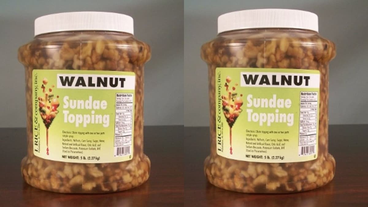 Large plastic jars of I.Rice & Company walnut sundae topping filled with chunky walnuts in syrup.