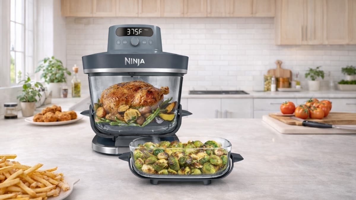 Ninja Crispi Pro glass air fryer cooking food in clear bowl