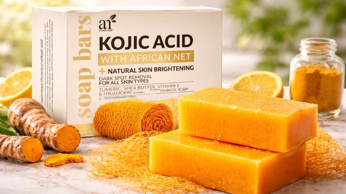 Kojic acid soap bars with African net sponge, turmeric root, and citrus slices for natural skin brightening and dark spot removal