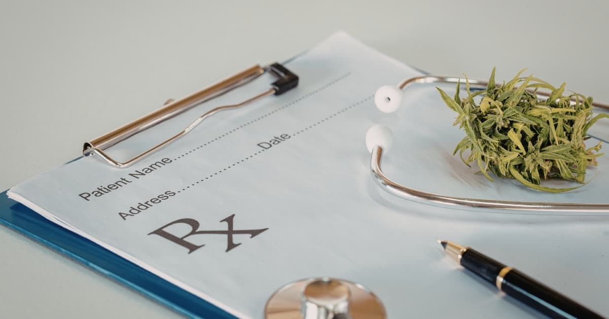 Medical cannabis prescription form with stethoscope, pen, and cannabis flower on clipboard